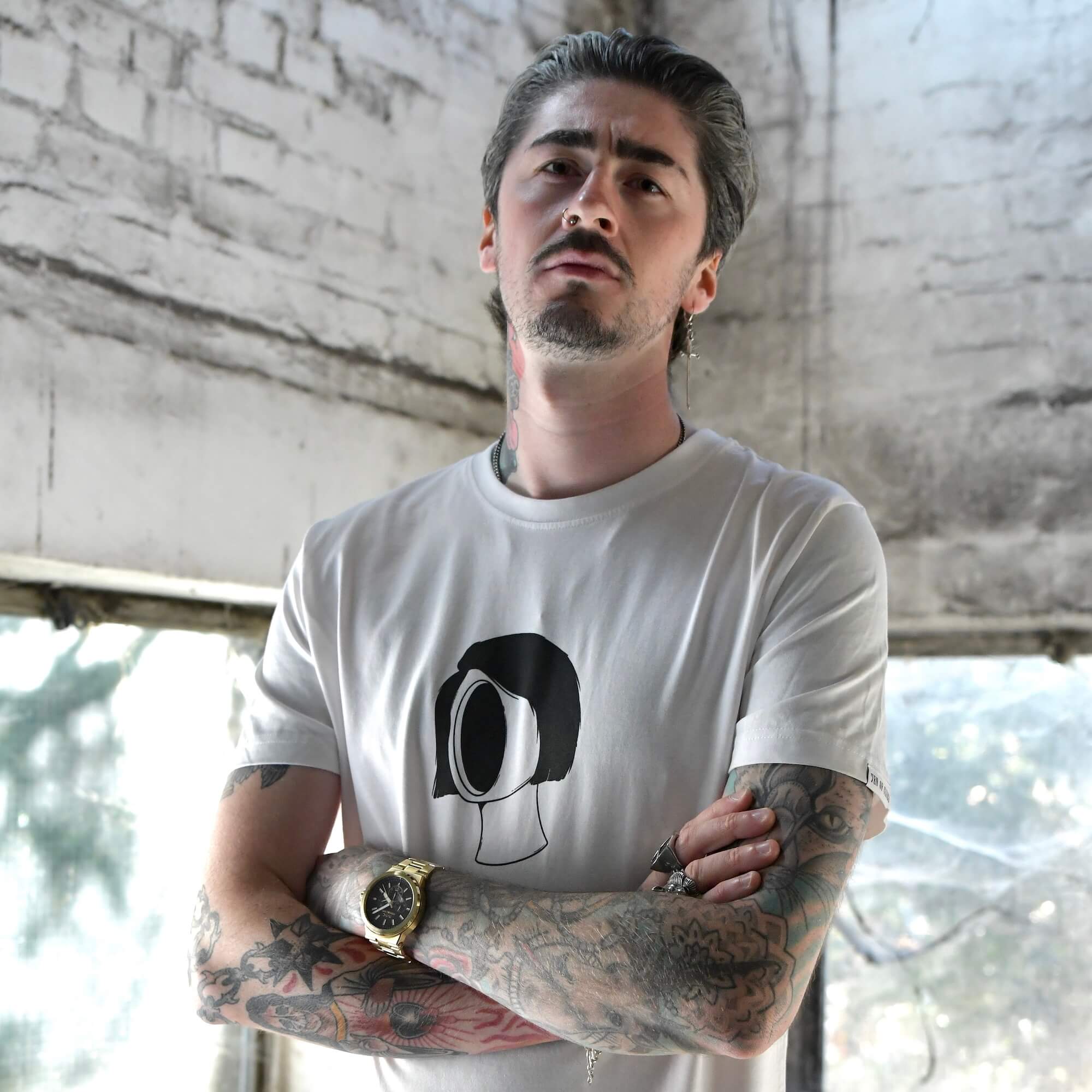 Model wearing Blank Stare Tee white graphic t-shirt with chest print | alt streetwear by TEN OF CLUBS