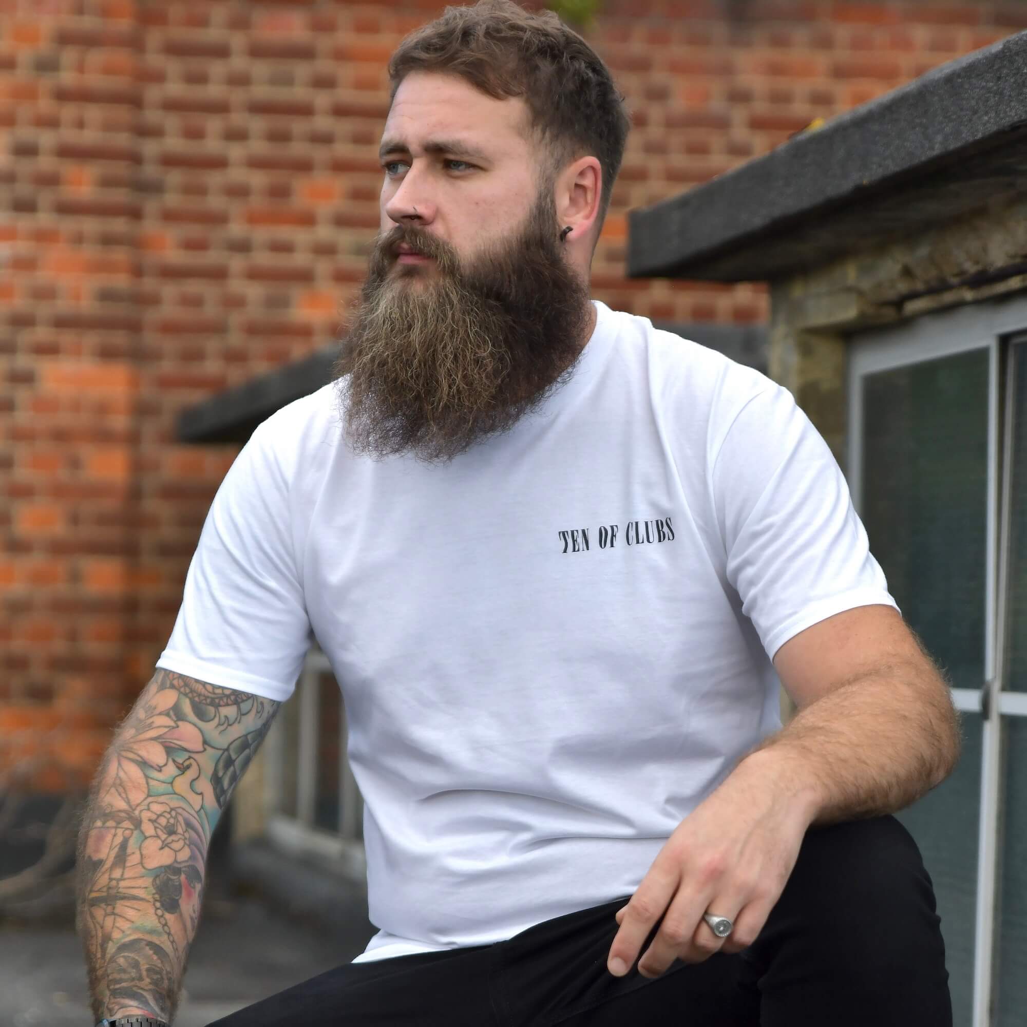 Model wearing Rise And Shine Tee white graphic t-shirt with TEN OF CLUBS chest print | alt streetwear