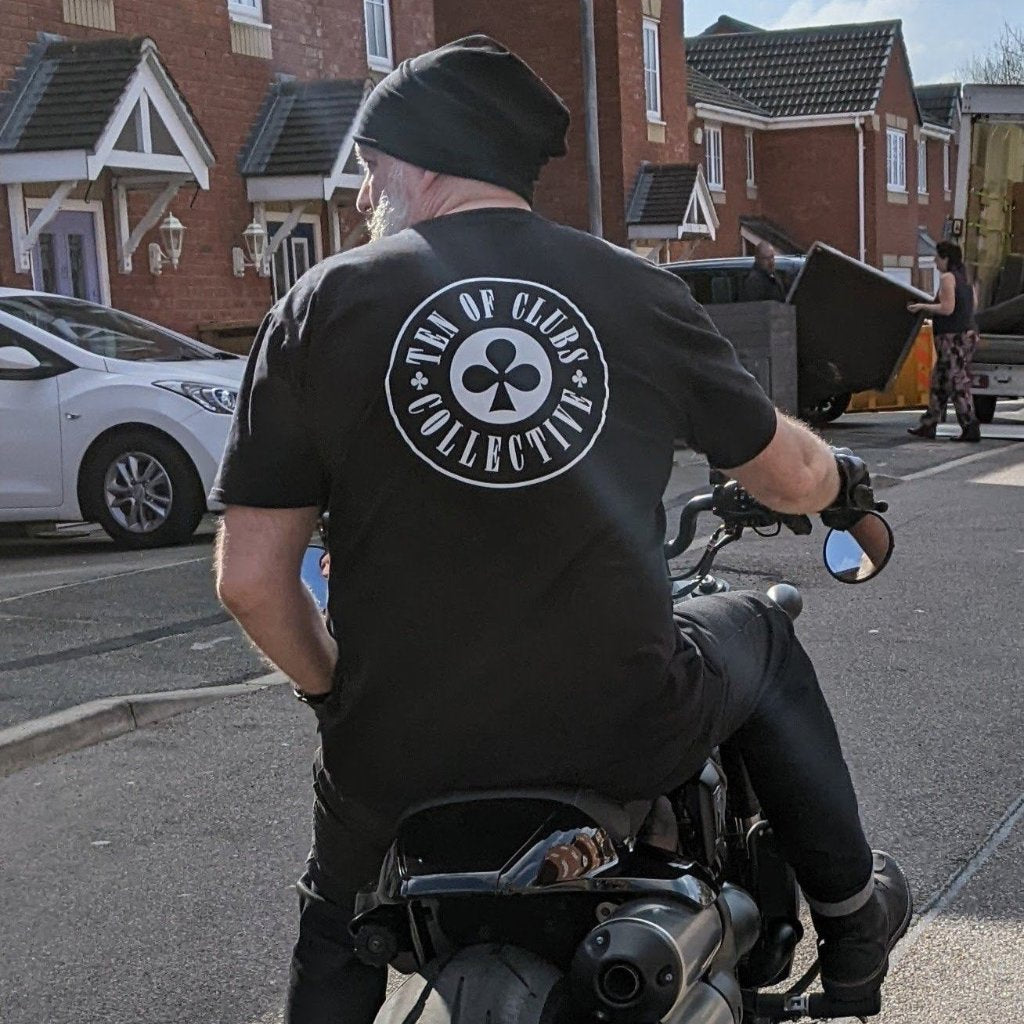 Man riding a motorbike in a TEN OF CLUBS Gunslinger Tee