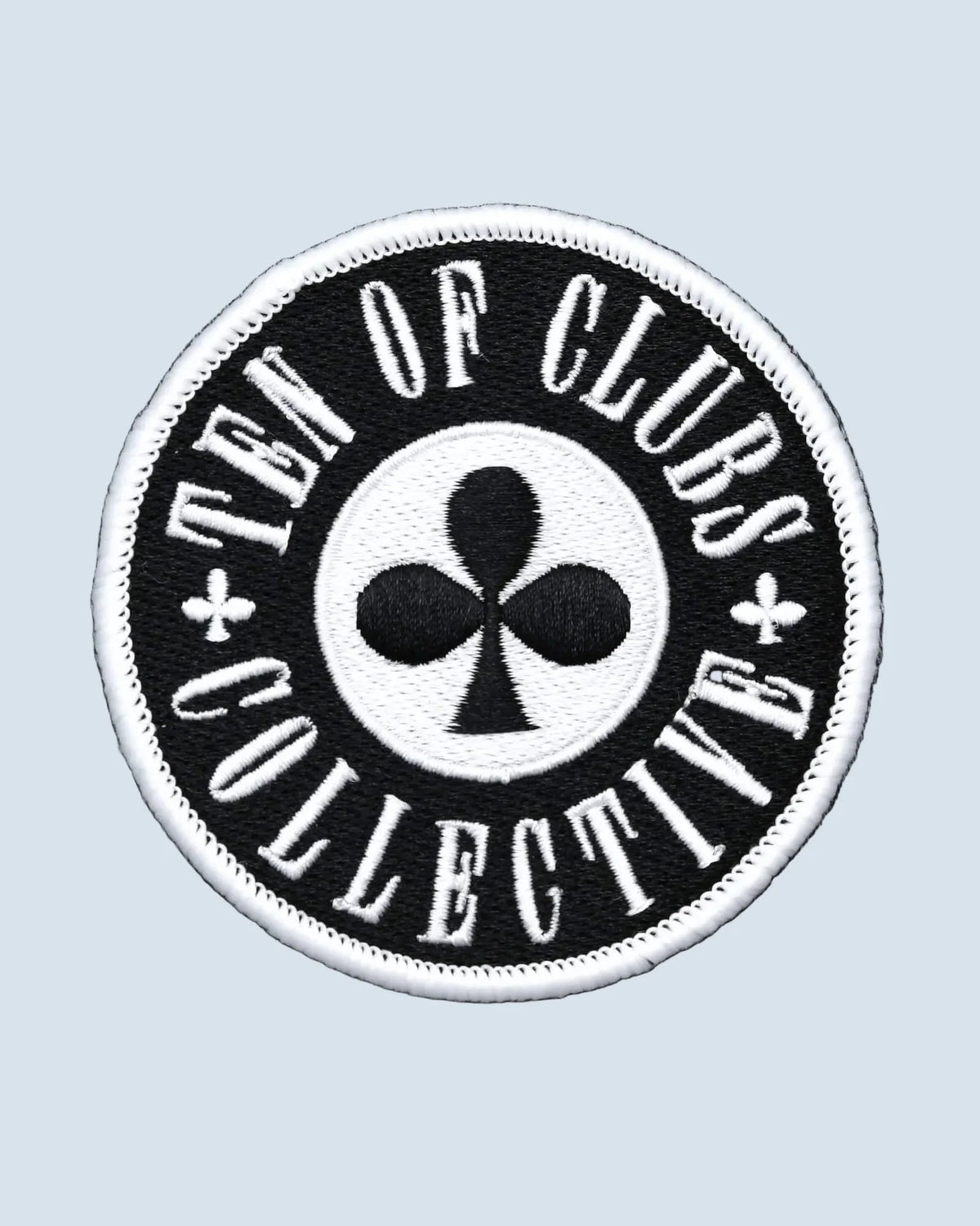 Round black TEN OF CLUBS Collective Patch with white embroidered lettering and border surrounding a central club symbol.