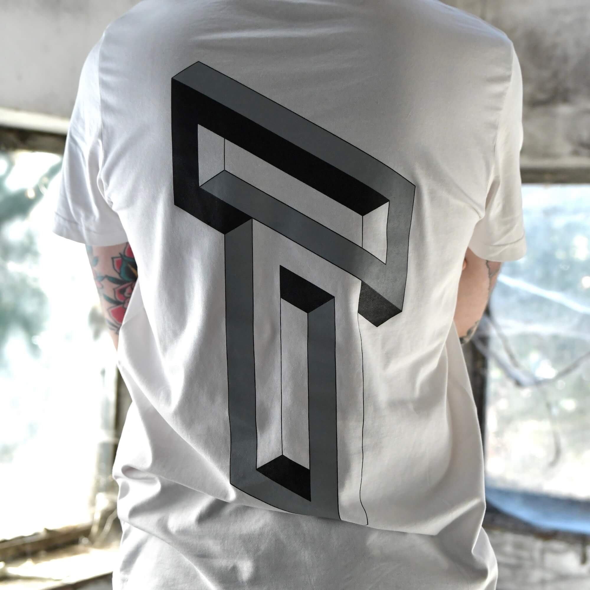 Model wearing Blank Stare Tee white graphic t-shirt with optical illusion back print | alt streetwear by TEN OF CLUBS