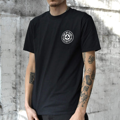 Model wearing Gunslinger Tee black graphic t-shirt with TEN OF CLUBS COLLECTIVE logo chest print | alt streetwear by TEN OF CLUBS