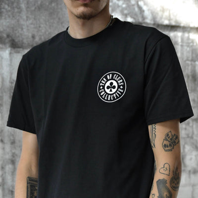 Model wearing Gunslinger Tee black graphic t-shirt with TEN OF CLUBS COLLECTIVE logo chest print | alt streetwear by TEN OF CLUBS