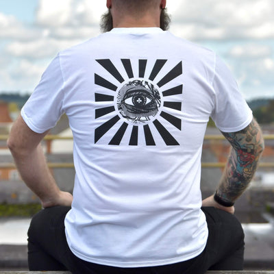 Model wearing Rise And Shine Tee white graphic t-shirt with Eye of Providence back print | alt streetwear by TEN OF CLUBS
